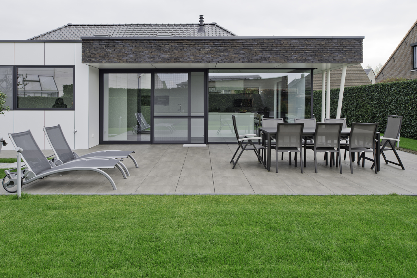 villa avec grande terrasse avec de grandes fenêtres en aluminium noir